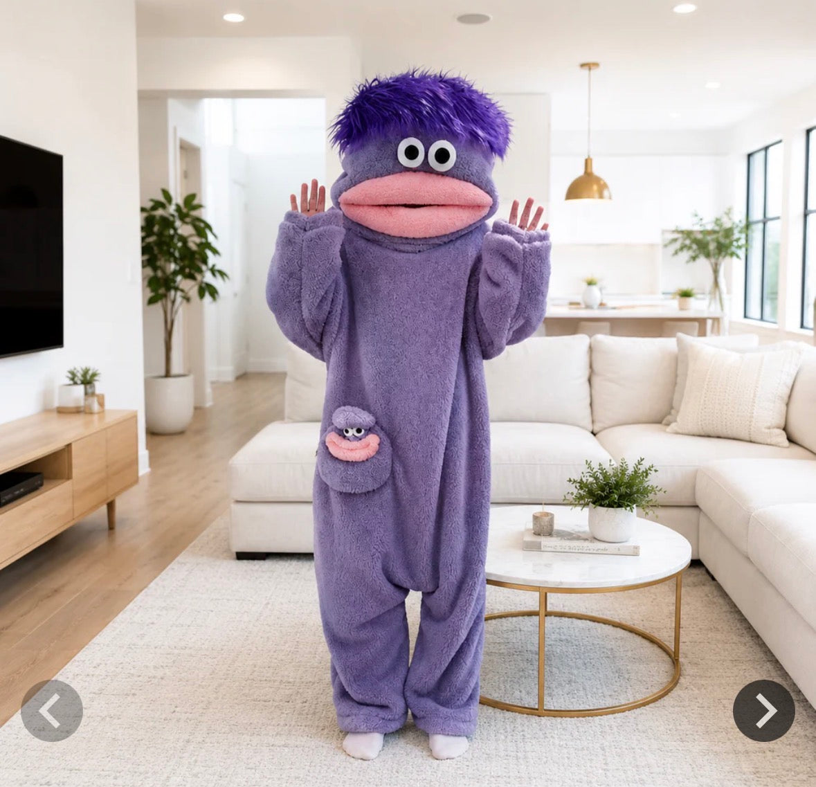 Green monster onesie with pink mouth and brown hair