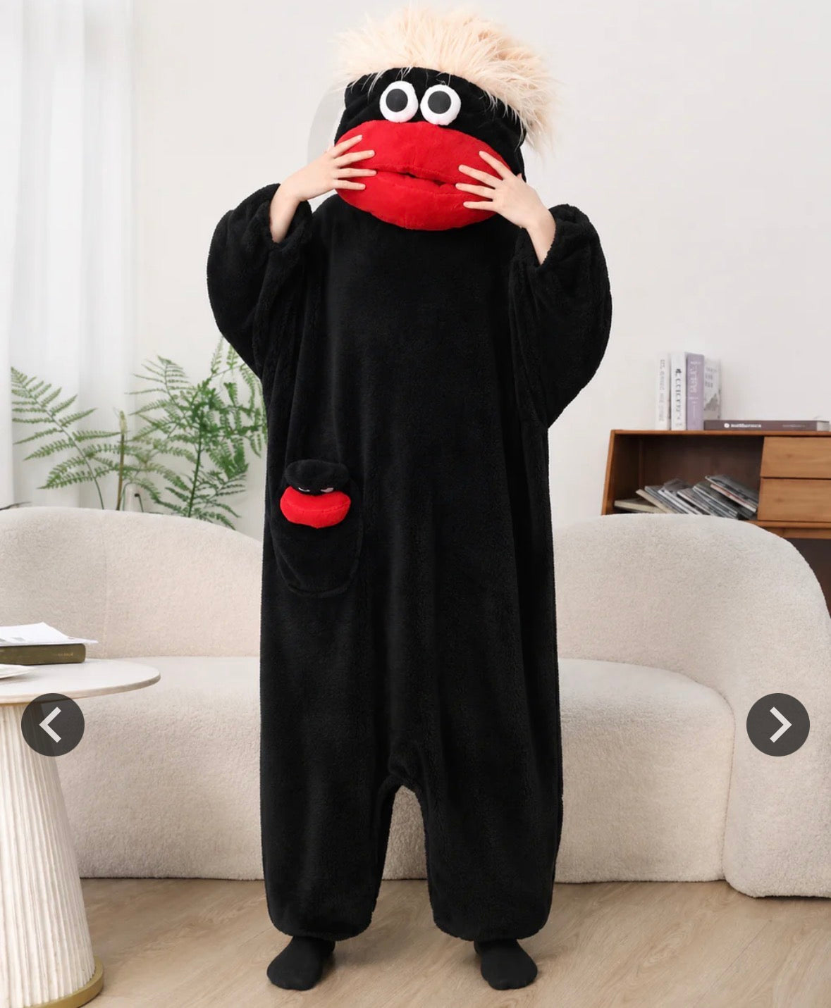 Black monster onesie with red mouth and white hair